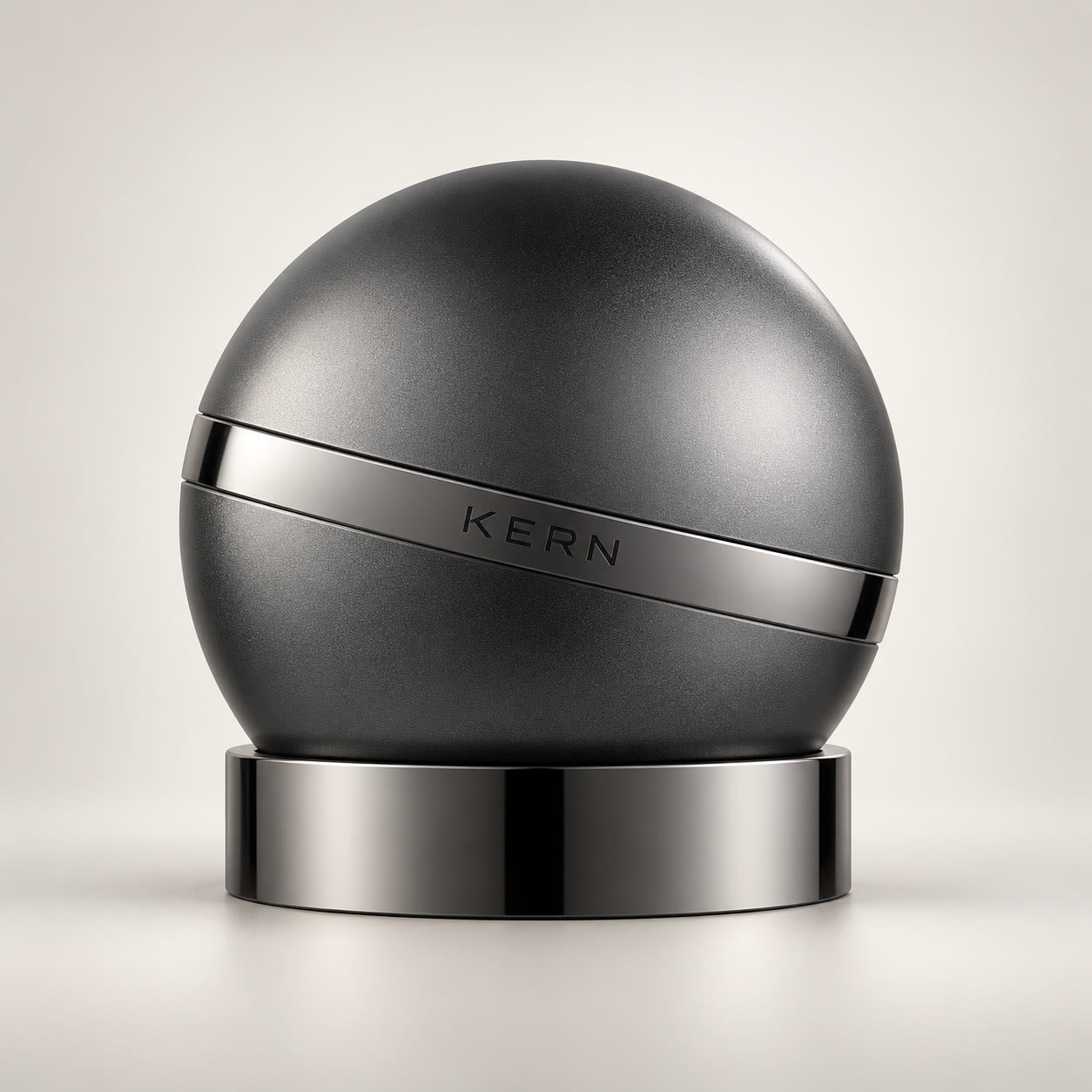 KERN 01 electric nail clipper: matte graphite sphere with a chrome band on its chrome charging base